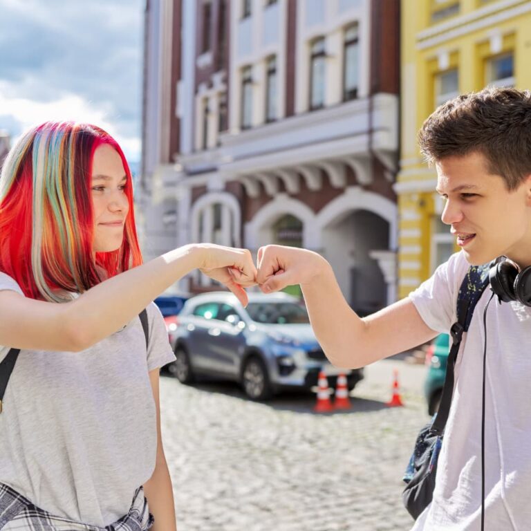 Two friends greet each other with fists to say hello