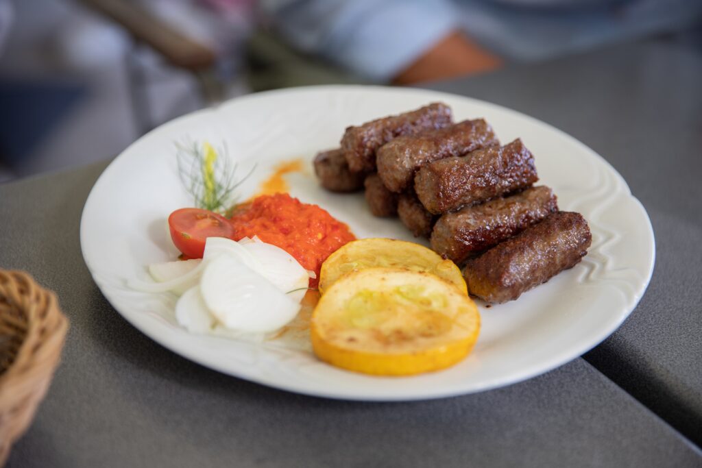A plate of ćevapćići as one of the dishes to try in Serbia.