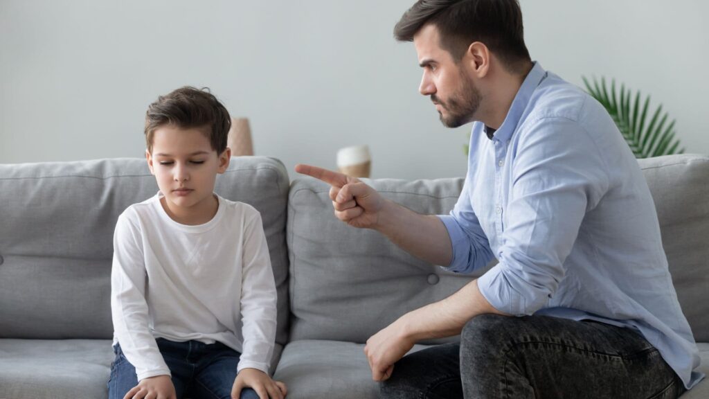 A father is criticizing an child that is sulking