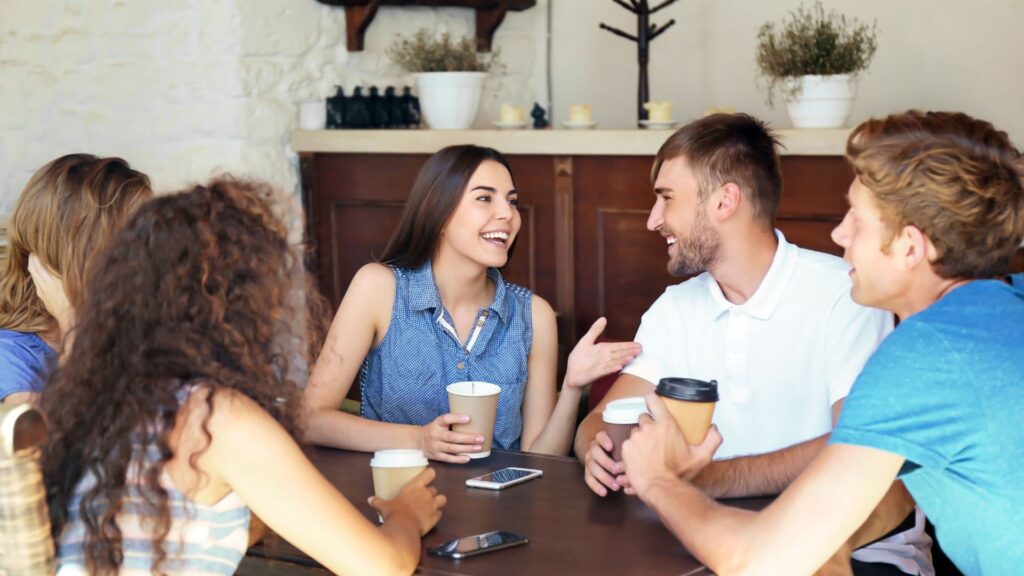 Young Serbian people laughing and drinking coffee
