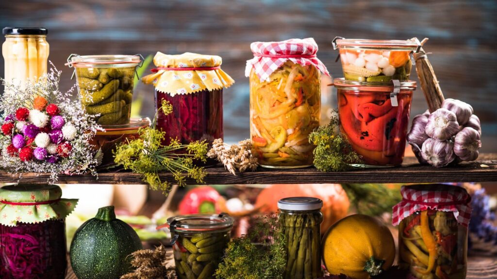 Various pickled vegetables in jars on a shelf