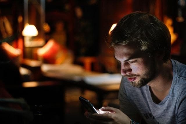 A young man looking at his smartphone.