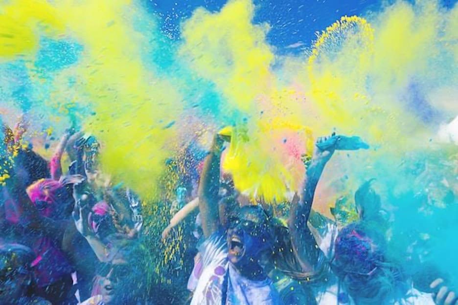 People dancing and splashing colors.