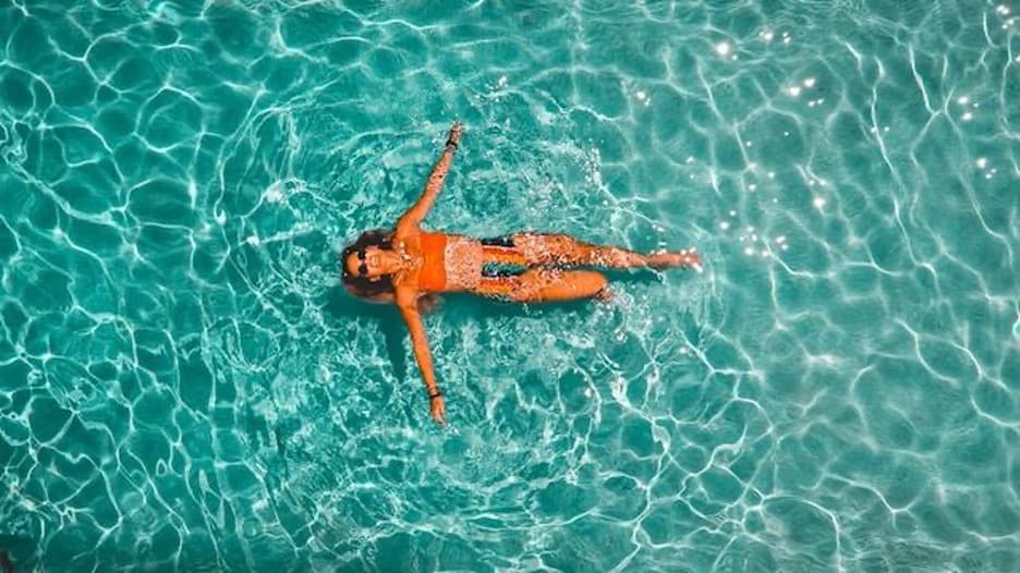 A lady floating in the sea.