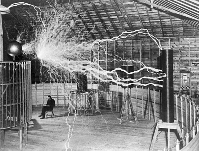 Nikola Tesla with his equipment.