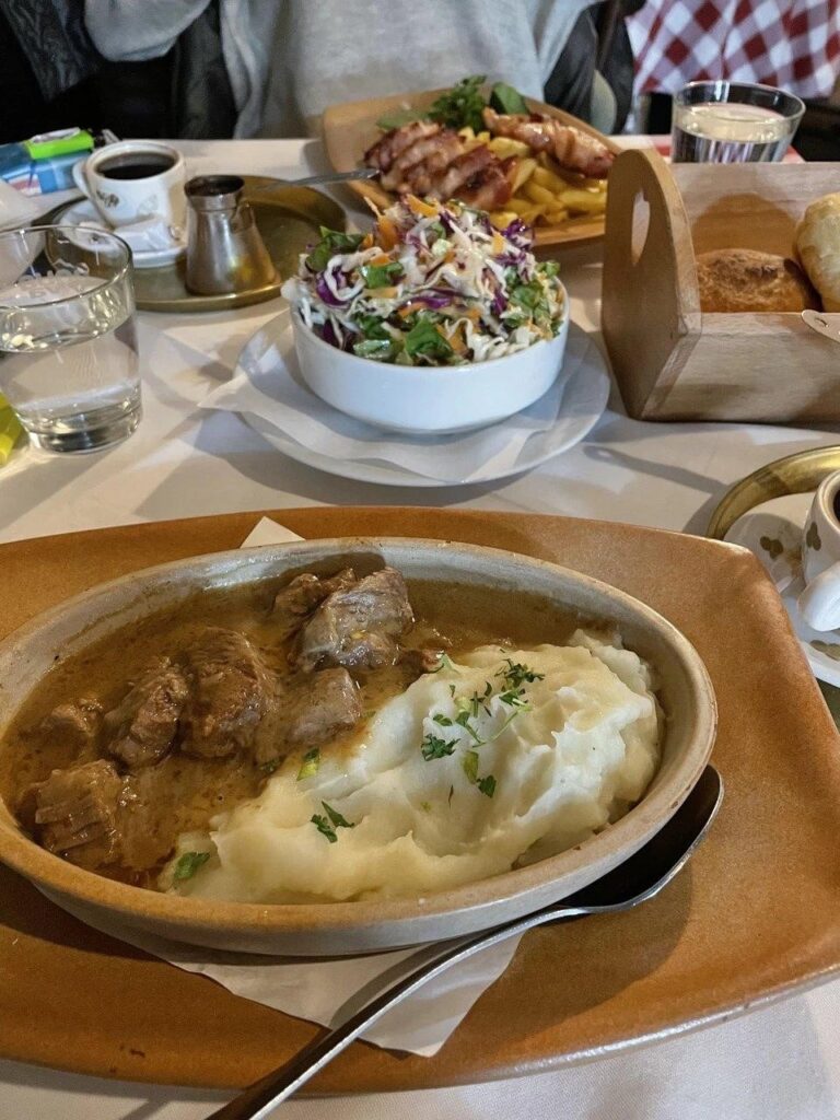 Food and coffee on a tavern table.
