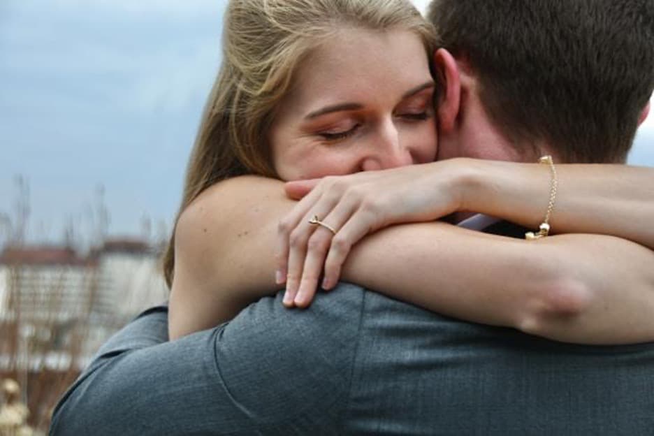 A man and a woman hugging.