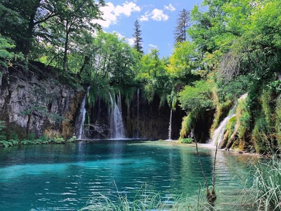 Blue lake with multiple waterfalls
