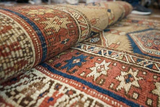 Serbian traditional rug in earthy colors, with elaborate patterns.