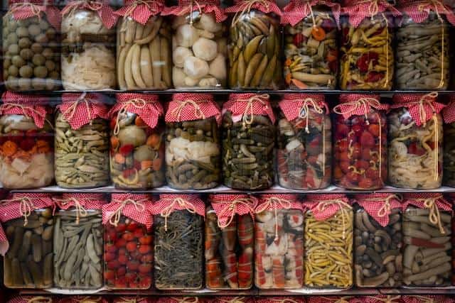 Jars of canned goods neatly arranged on shelves.