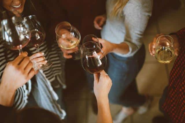 A group of people holding wine glasses at a house party — an important part of Serbian social culture.