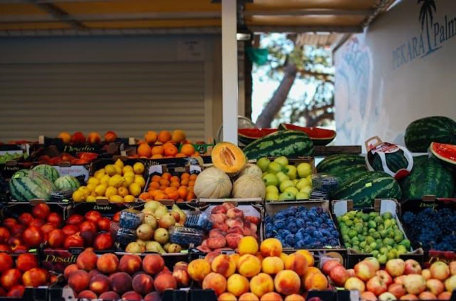 A market stall brimming with fruits.