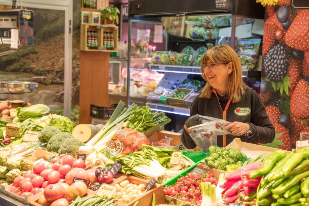 A shop clerk in a vegetable shop.
