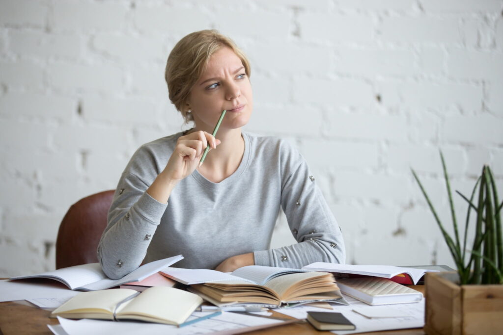 A woman studying with a confused expression
